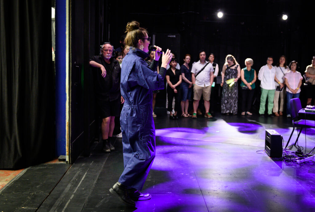 Julia Ulehla singing on stage at the Vancouver Playhouse.